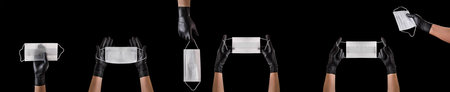 Hand in black gloves wearing disposable face mask isolated on black background. Concept of medical...