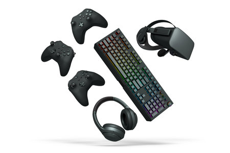 Collection of modern gaming accessories including headset, controller, keyboard, and VR gear...