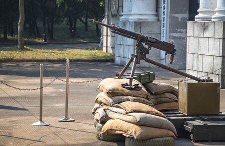A rusty machine gun on the sandbag