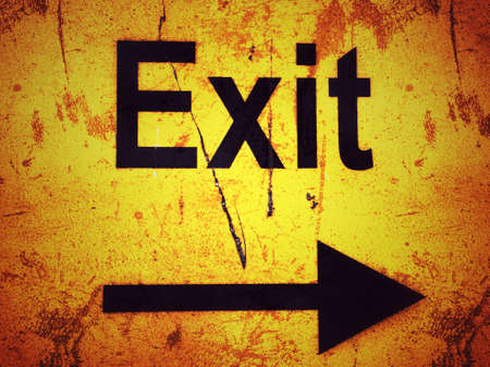 Exit sign on a yellow grunge background