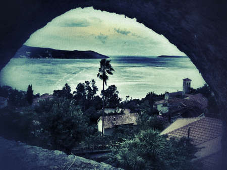 View at the sea trough the stone arch