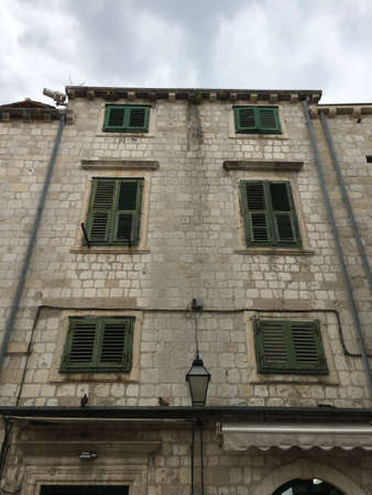 Green wooden windows at the stone houseの写真素材