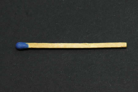 Matchstick against black background