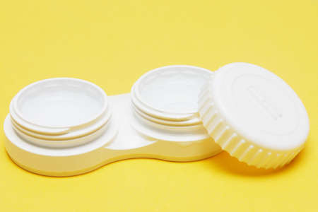 Contact Lens case with contact lens inside against plain backgroundの写真素材