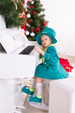 girl in costume leprechaun playing the pianoの写真素材