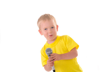 boy sings with microphone isolated on white backgroundの写真素材