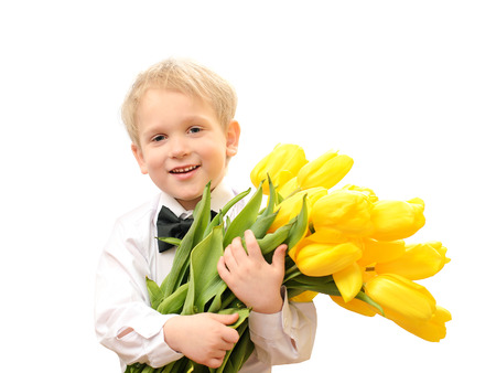boy in white shirt with bouquet of yellow tulips isolated on white background
