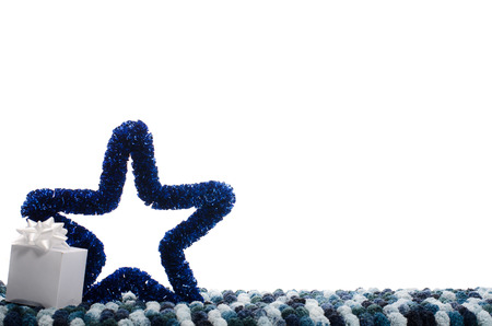 christmas background with deep blue decorative star and small box of gift on whiteの写真素材