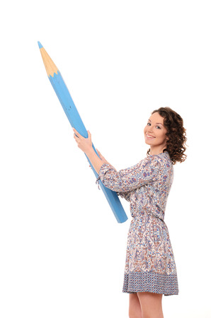 young attractive smiling woman with wavy hair in gown with huge blue pencil isolated on white backgroundの写真素材