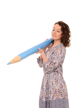 young attractive woman with wavy hair in gown with huge blue pencil isolated on white backgroundの写真素材