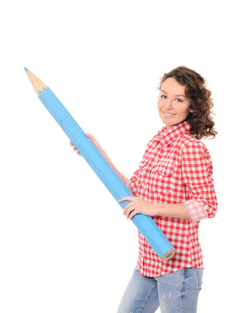 young smiling pretty woman with wavy hair in checkered red shirt with giant blue pencil isolated on white backgroundの写真素材