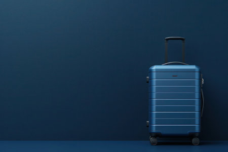 A rectangle-shaped electric blue suitcase is placed in front of a blue wallの素材