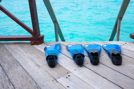 snorkeling fins on sea deckの写真素材