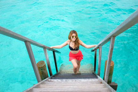 women step up on sea ladderの写真素材