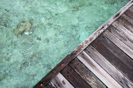 wooden dock triangle over clear waterの写真素材