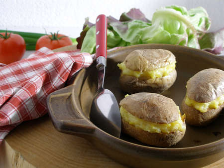Baked potatoes stuffed with their own flesh seasonned with olive oil,butter and chivesの写真素材