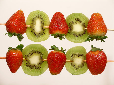 Strawberries and kiwi on skewers, waiting to be eaten like a lollipopの写真素材