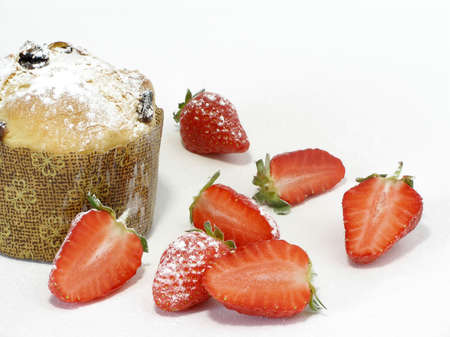 Italian pannetoni served with strawberries sprinkled with icing sugarの写真素材