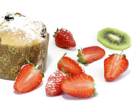 Italian pannetoni served with strawberries and kiwi, sprinkled with icing sugarの写真素材