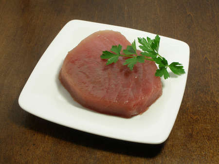 Raw steak of tuna fish on a small plateの写真素材