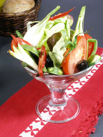 Raw fresh vegetables served in a cocktail glass redy to eat with bread asideの写真素材