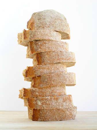 Bread cut and pilled up on the cutting boardの写真素材