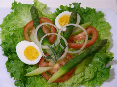 On plate,ready to eat a spring salad with green asparagusの写真素材