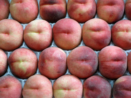 Yellow peaches displayed to be soldの写真素材