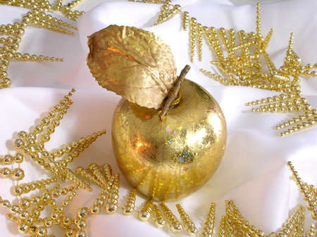 Christmas golden apple decoration with a candle reflectionの写真素材