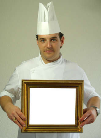Chef Gabriel is holding a frame for you to write insideの写真素材