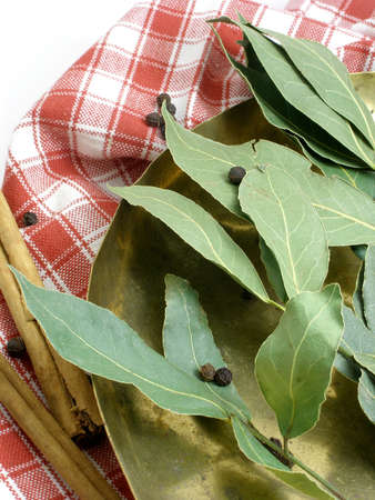 Dried bay leaves in a coper scale trayの写真素材
