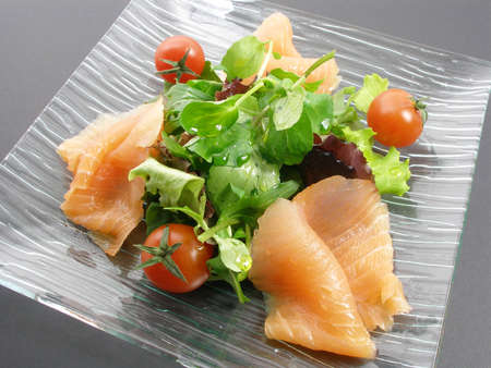 Salmon apetizer salad in a glass plateの写真素材
