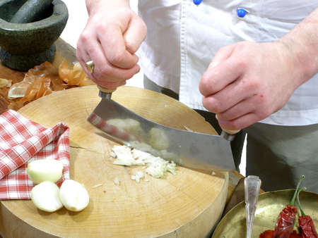 a chef is chopping onionsの写真素材