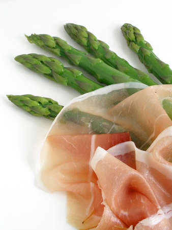 Green asparagus and prosciutto served on a platter        の写真素材