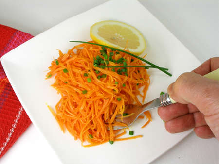 Who is eating the salad of carrot の写真素材