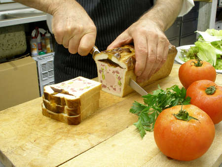 A chef is cutting a patの写真素材