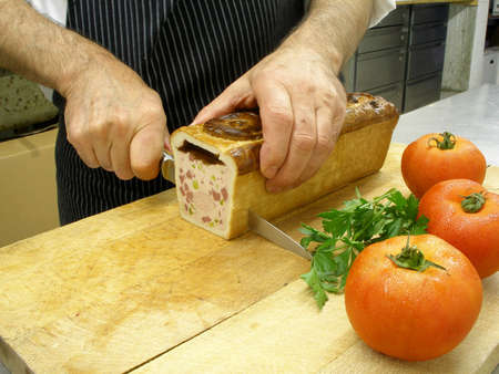 A chef is cutting a pateの写真素材