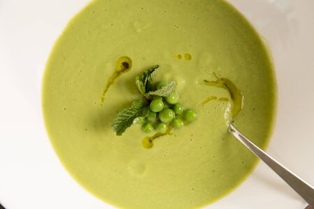 Refreshing Summer Pea & mint soup finished with extra virgin olive oilの写真素材