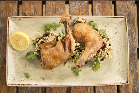 Confit Chicken with lemon, olive & herb cous cousの写真素材