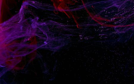 Watercolor futuristic ink in water on a black background. Cosmic color magic background.