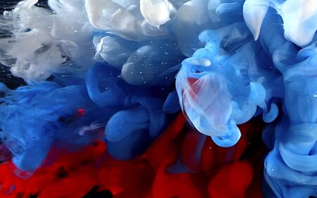 White, blue and red watercolor ink in water. Abstract background. Cool trending screensaver. A powerful explosion of colors.の写真素材
