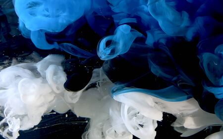 Blue, white and black watercolor ink in water. A powerful explosion of colors. Stylish trending screensaver.の写真素材