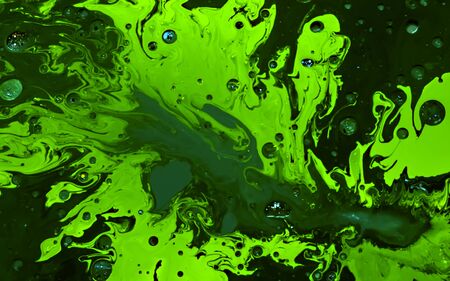 Green watercolor ink in oil water. Cool trending screensaver. Abstract trending background.の写真素材