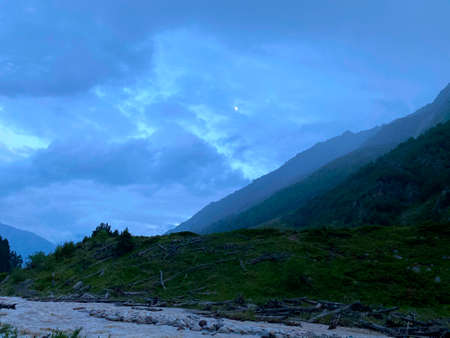 Aerial view stormy mountain river evening landscape. Green slopes of the northern Elbrus region. Beautiful blue sky.の写真素材