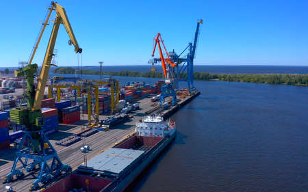 SAINT PETERSBURG, RUSSIA - JULY 17, 2020: Aerial view of a row of construction or cargo cranes on...