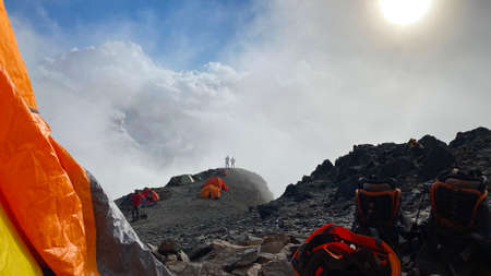 A breathtaking view of the mountains in the clouds from the tent. Beautiful landscape of North...