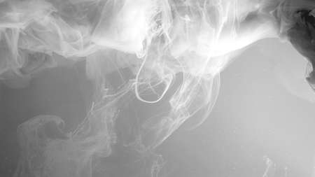 Environmental pollution concept. White cloud of ink on a gray background. Beautiful abstract background. Chic wallpaper for your desktop. White watercolor paints in water on a gray background.の写真素材