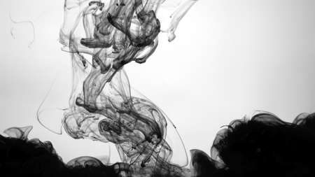 Environmental pollution concept. Beautiful wallpaper for your desktop. Awesome abstract background. Black cloud of ink on a white background. Drops of black ink in water. Cosmic star background.の写真素材