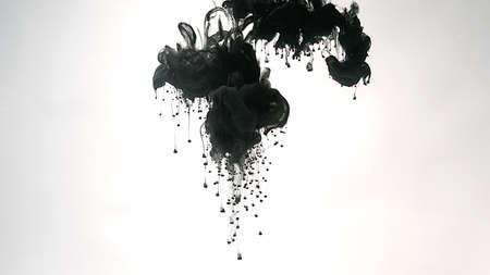 Environmental pollution concept. Desktop wallpaper. Black cloud of ink on a white background. Creative hyptonic background. Black watercolor paints in water on a white background.の写真素材