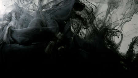 Drops of black ink in water. Cosmic star background. Environmental pollution concept. Beautiful wallpaper for your desktop. Awesome abstract background. Black cloud of ink on a white background.の写真素材